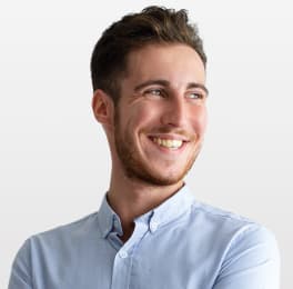 Young man smiling in blue shirt 